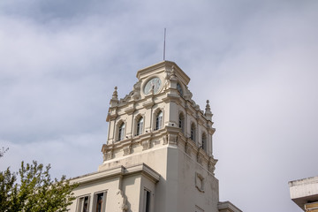 Fototapeta na wymiar Clock tower of building near Plaza San Martin at Rivadavia and Rosario de Santa Fe street corner - Cordoba, Argentina