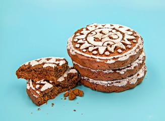 pile of gingerbreads with two broken pieces isolated on blue