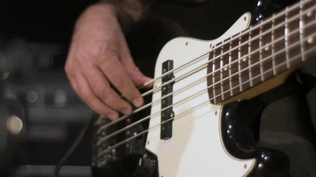 Bass player grooving in slow motion.