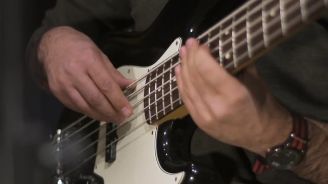 Bass player recording a solo in slow motion.