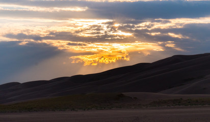 Sunset over rolling sand dunes