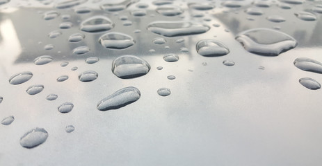 Fototapeta na wymiar Water Drops background on the glossy surface