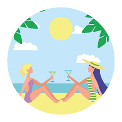 two woman sitting on beach with cocktails in hands