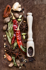 Various whole indian spices on wooden table. Top view with copy space.