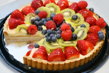 fresh cheese cake with fruit on top