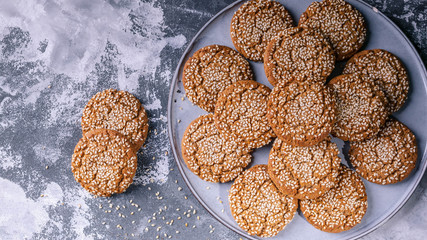 Oatmeal cookies with sesame seeds on a concrete background. Top view
