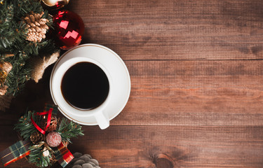 Christmas workplace, cup of coffee and  Christmas tree on a brown wooden textured table. Top view Christmas background.Place for you text.