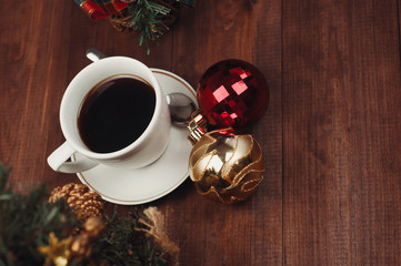 Christmas close-up of Christmas balls and cup of coffee.Top view of a Christmas workplace.