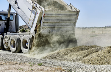 Fototapeta Dump Truck spreading Gravel on Driveway obraz