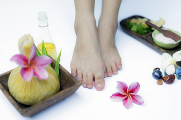 Fototapeta na wymiar Spa treatment and product for feet spa with flowers and water, wooden background; select and soft focus.