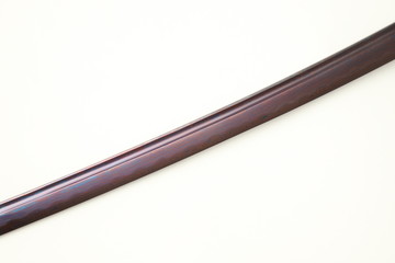 Folded steel blade of Japanese sword  (Chinese made) red color by titanium coated isolated in white background