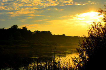 Obraz na płótnie Canvas bright scenic sunset on the river. beautiful evening landscape. natural summer nature