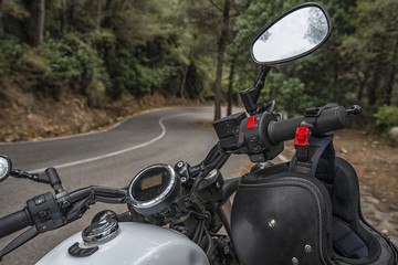 Motorcycle standing on downhill road