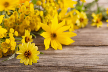 yellow flowers on old wooden background