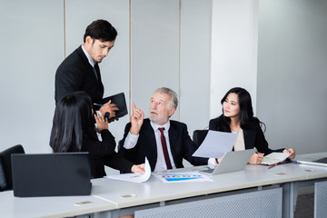 group of successful businessman. Discussion of the business profits of the company in meeting roon or conference room.