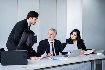 group of successful businessman. Discussion of the business profits of the company in meeting roon or conference room.