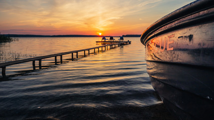 Sunrise landscape with rescue boat and wooden pier.
