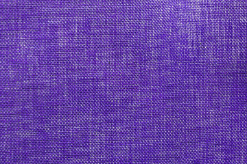 Close-up of the purple textile texture, background and wallpaper. The texture of purple fabric textile upholstery of furniture. High-quality macro photography.