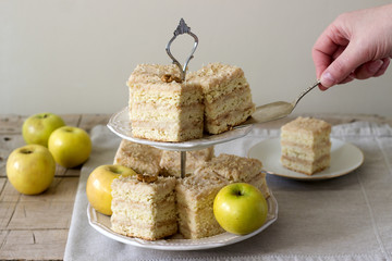 Pieces of apple cake and apples on a wooden table. Rustic style.