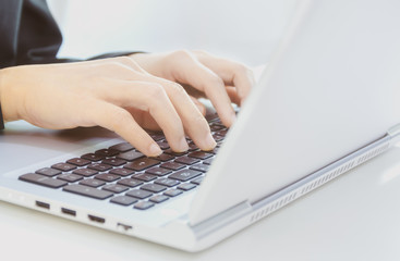 Fototapeta na wymiar selective focus, Cropped shot of hands typing on laptop's keyboard.