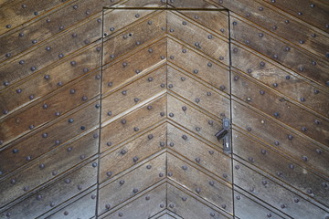 Wooden castle door with metal pins 