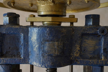 Old, vintage coin pressing manufacturing machine in blue and gold color