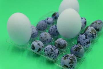 quail eggs over dark old background. Chicken and quail eggs on the black table. Easter background. Eco products. Copy space