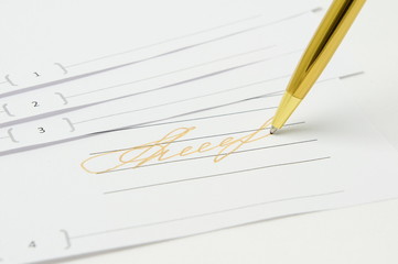 Gold signature. Golden pen is on the document.