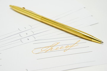 Gold signature. Golden pen lying on the document.