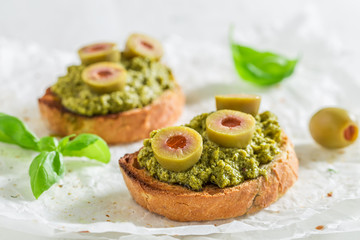 Closeup of bruschetta with green olives for a snack