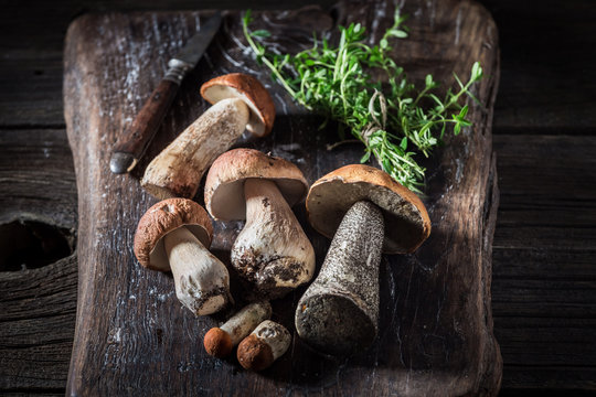 Wild mushrooms and herbs on the old board