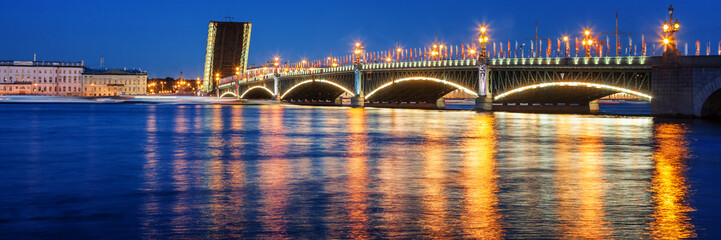 Fototapeta na wymiar Beautiful night cityscape, night view of St. Petererburga and illuminated bridges, traveling in Russia, panorama banner format