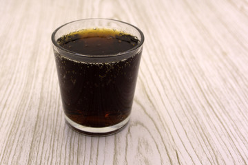 in an ice glass. A slightly carbonated malt beverage made from barley and hops. Also known as .