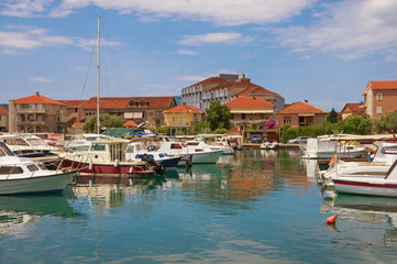Fototapeta na wymiar Sunny Mediterranean landscape with fishing boats in harbor. Montenegro, Tivat city, view of Marina Kalimanj