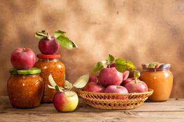 Jam made from apples in glass jars, apples in a wicker basket