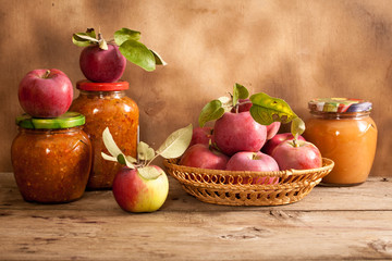 Jam made from apples in glass jars, apples in a wicker basket