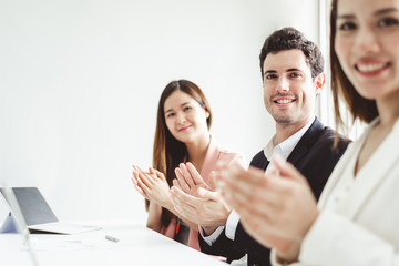 Business people clapping hands during meeting in office for their success in business work