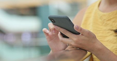 Close up of woman use of mobile phone in shopping mall
