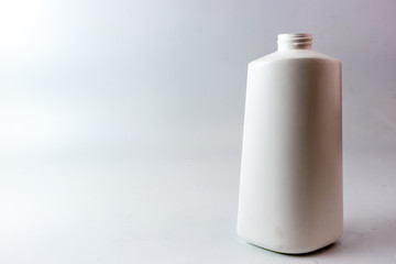 White plastic bottle with spiral on top mouth