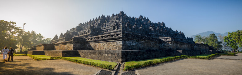 Borobudur temple and bell-enshrined Buddhas looking over the jungle and mountains of Java, Indonesia