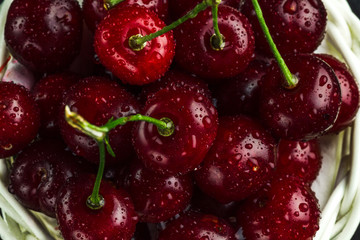 Red, ripe cherries closeup on a dark background