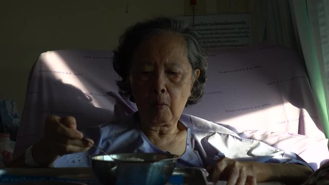 senior woman patient eating hospital food