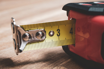Macro Of A Solid Measuring Tape With Pulled Out Scale Lying On A Table