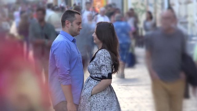 Young lovers couple stand still together in middle of fast moving crowded street, timelapse