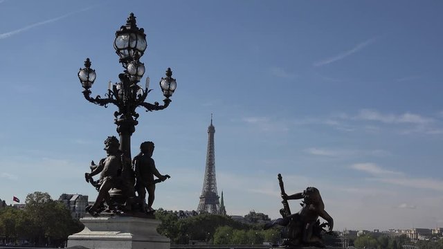 Beautiful statues and Eiffel tower in background, art sights cape, Alexandre III Bridge, Paris