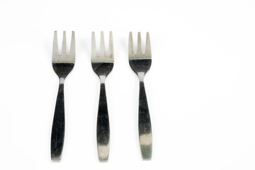 Cutlery arranged on a white kitchen table. Accessories for kitchen and restaurant use.