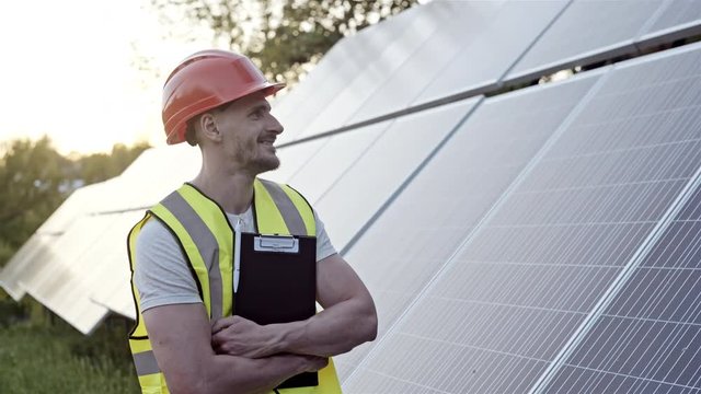 Engineer watching row of solar panels