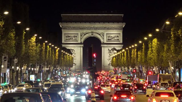 Many cars on night crowded street of Arc de Triomphe, Arch of Triumph Paris city lights