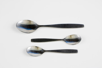 Cutlery arranged on a white kitchen table. Accessories for kitchen and restaurant use.