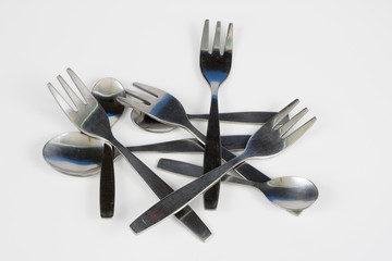 Cutlery arranged on a white kitchen table. Accessories for kitchen and restaurant use.